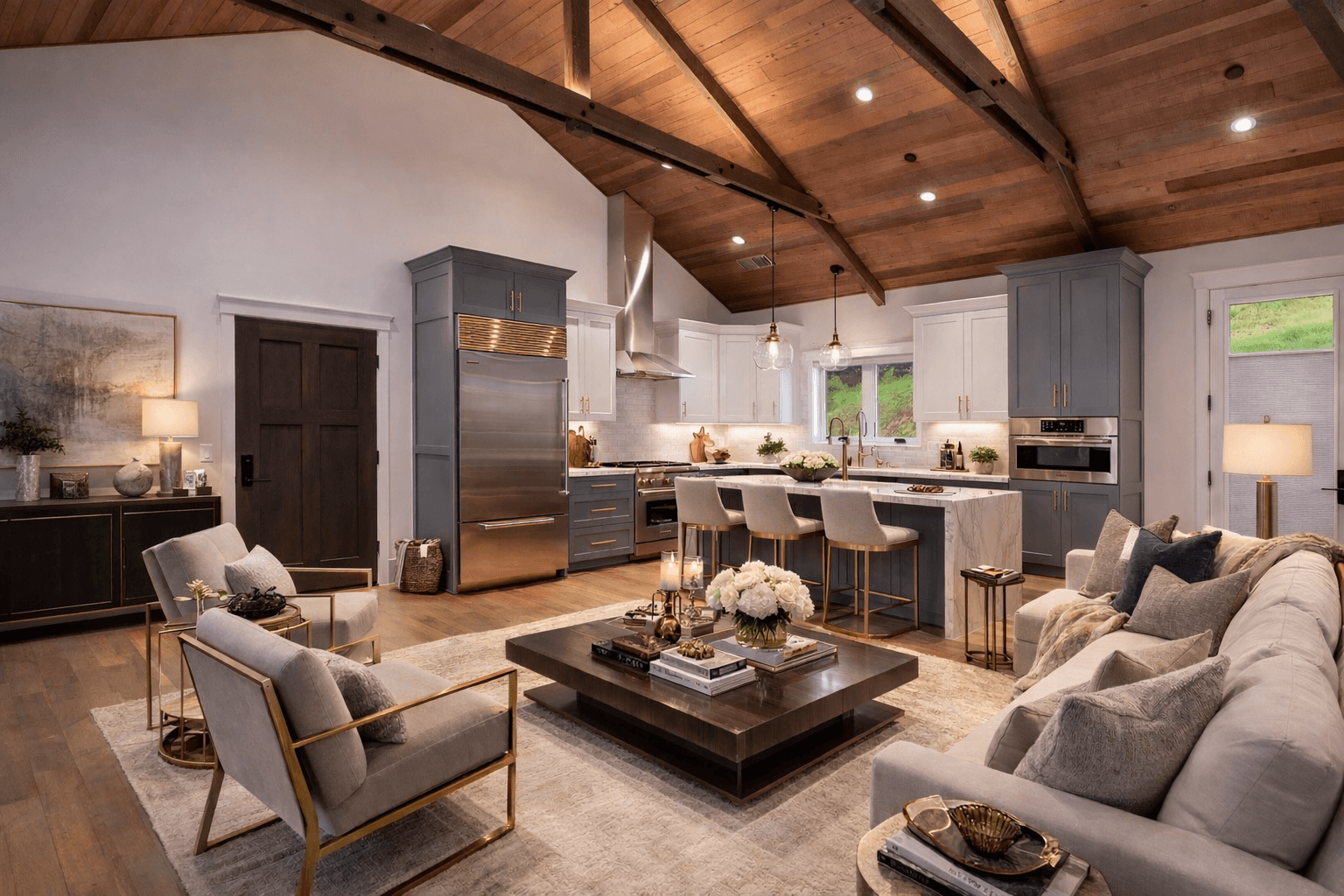 Open-plan Menton Builders living room and kitchen beneath a vaulted exposed-timber ceiling